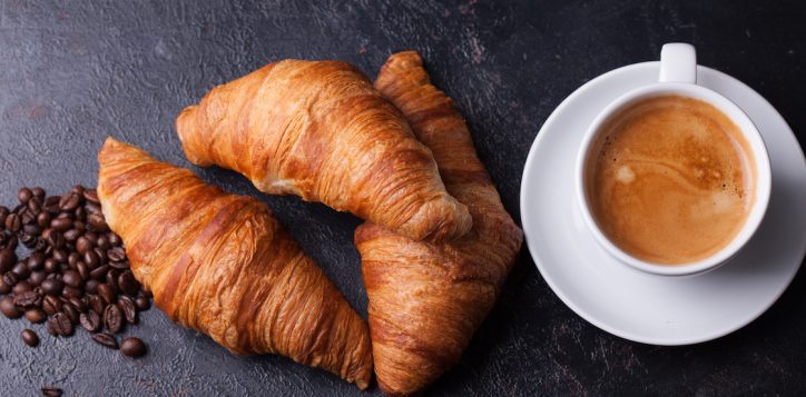 croissants-with-cup-of-coffee-and-coffee-beans-on-dark-wooden-table-2-2