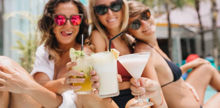 laughing-brunette-woman-pink-sunglasses-celebrating-something-with-friends-during-summer-rest-beautiful-tanned-ladies-drinking-cocktails-enjoying-vacation-1-2